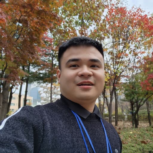 Viet-Anh Nguyen outdoors among autumn trees